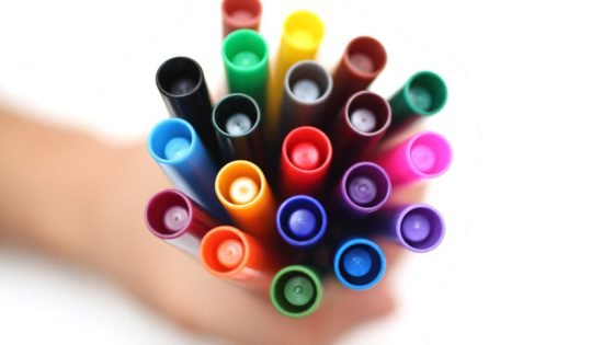 Photo of hand holding a bunch of markers