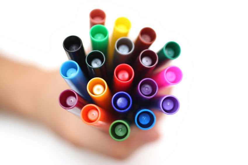 Photo of hand holding a bunch of markers