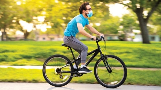 Guy riding bike with mask on